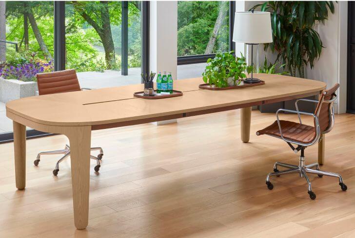 Meeting room with Nucraft conference table and two rolling chairs