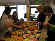 Women gathered around a table of food