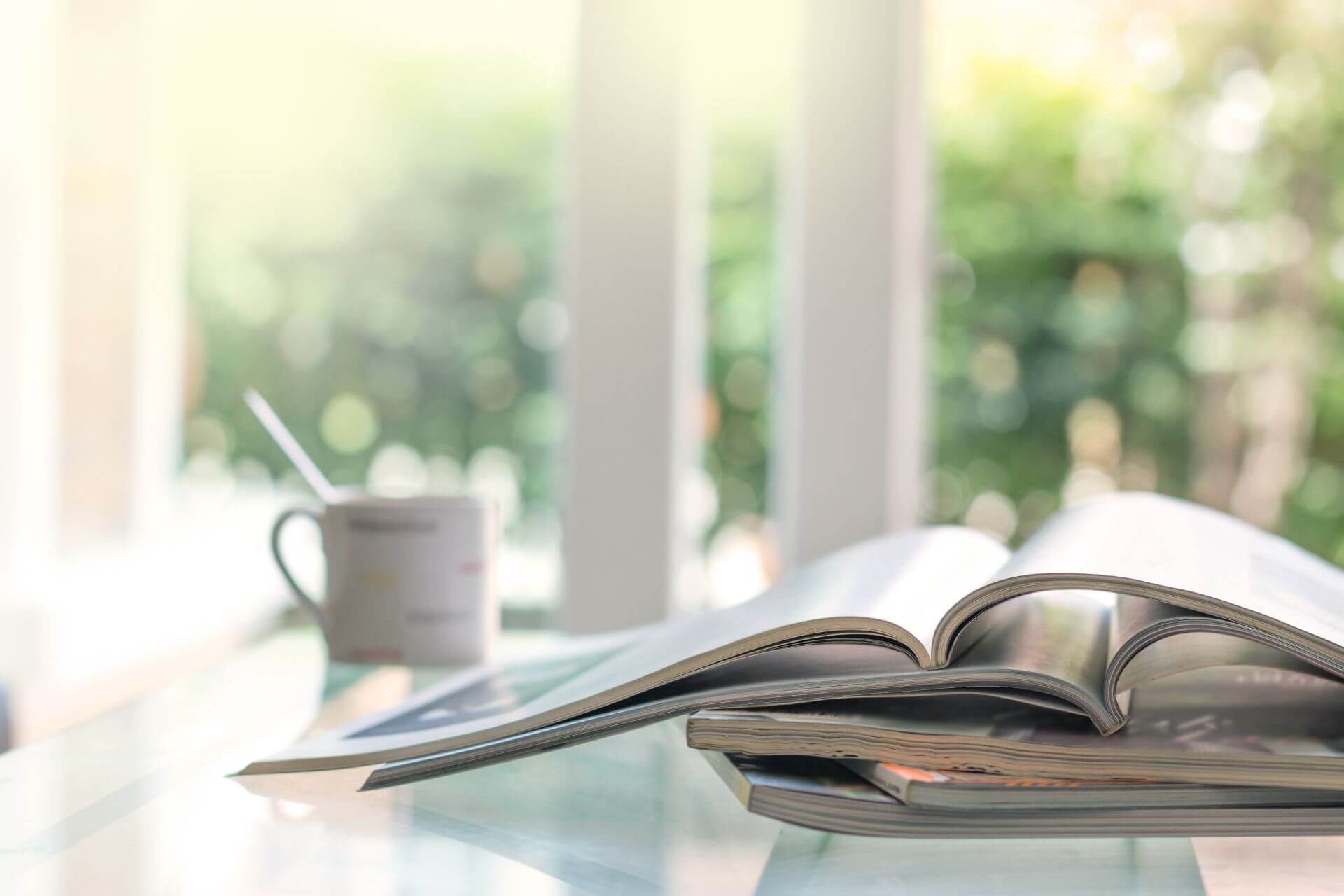 Cup and books on glass table